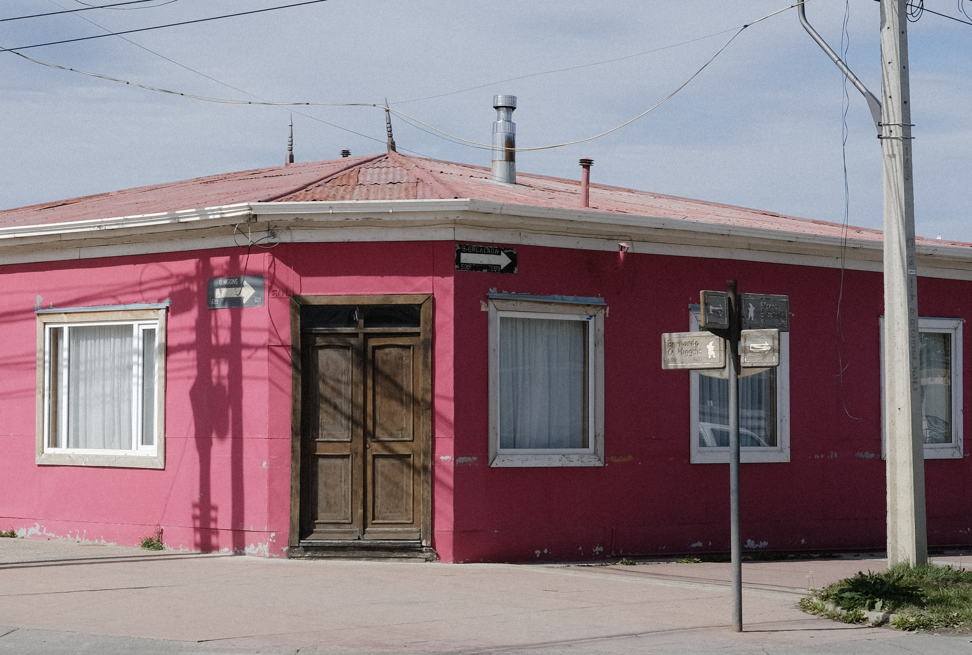 A pink corner house in a small town in Chile. Wes Anderson inspired photo.