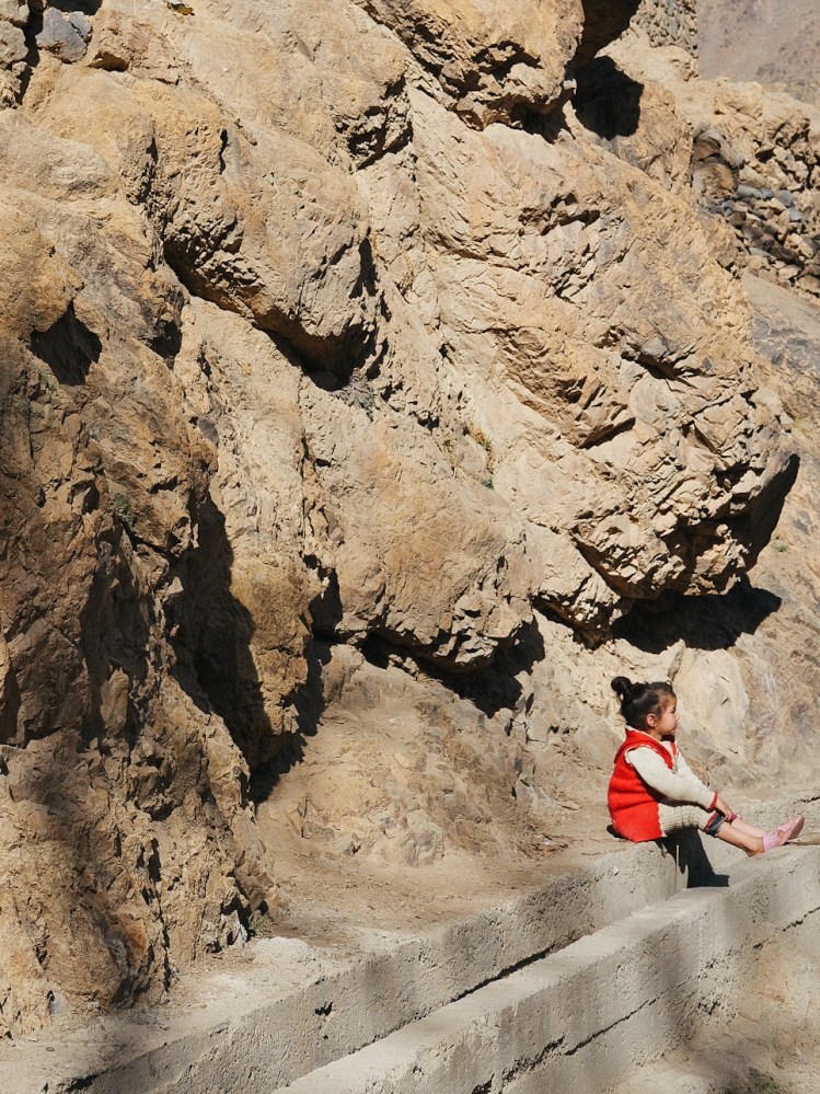 A little girl playing with her siblings in the Atlas Mountains